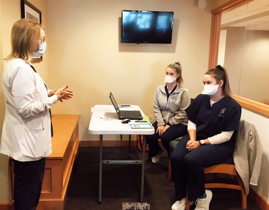 HopeHealth Hospice Clinical Educator Cynthia Brown, RN, CHPH, discusses hospice care with Salve Regina University senior nursing students Taylor Eaton (center) and Allison DeLuca (right).